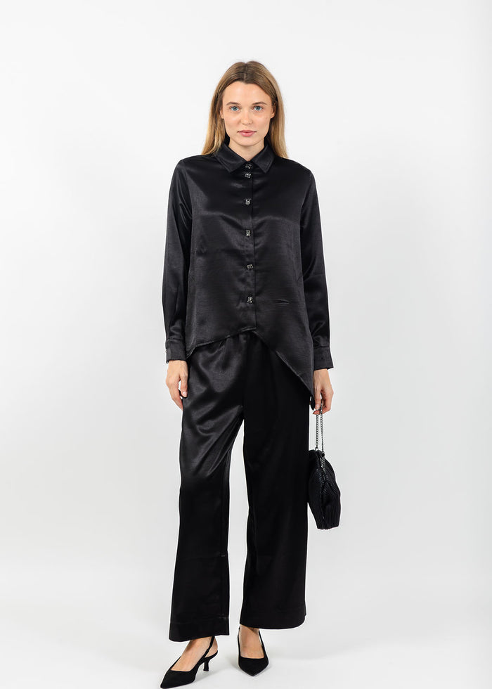Terra Modern Asymmetric Blouse in Black paired with matching Terra Satin Pants available at Barbara Katz