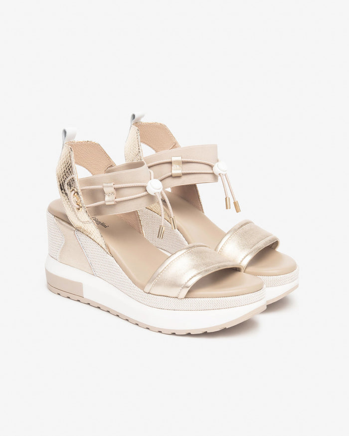 NeroGiardini Satcha Bungee Platform Wedge Sandal in Gold available at Barbara Katz