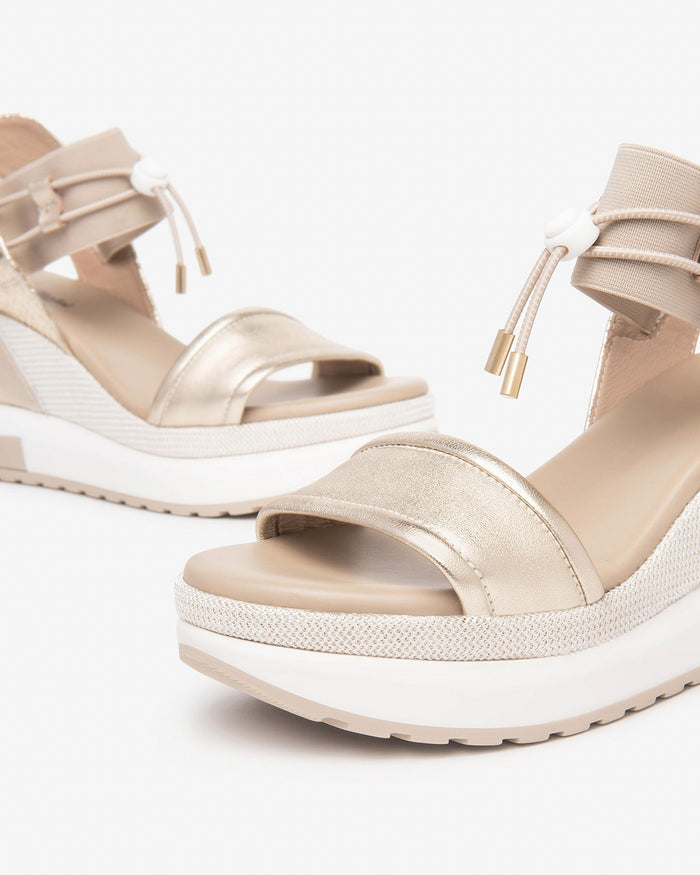 NeroGiardini Satcha Bungee Platform Wedge Sandal in Gold available at Barbara Katz
