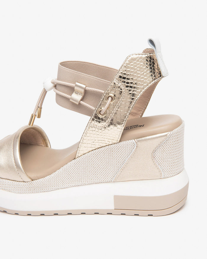 NeroGiardini Satcha Bungee Platform Wedge Sandal in Gold available at Barbara Katz