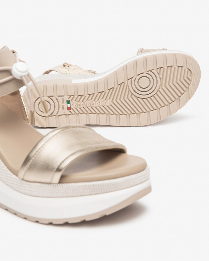 NeroGiardini Satcha Bungee Platform Wedge Sandal in Gold available at Barbara Katz